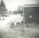 Snow blowing, looking toward our neighbor's home.