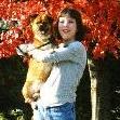 Binky with Serena in front of an autumn tree.