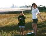 My girls in an empty lot with the Gulf behind them.