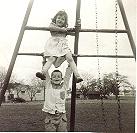 I am on the side of the swing set with my brother beneath me.