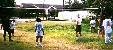 A volley ball game on the Fourth of July, in the little tree and grassy area in front of our apartments.