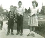 A view west from our front porch, my older brothers and sister with a cousin, Mike thinking he is out of the picture.