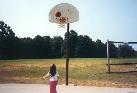 My daughter playing on the basketball court.