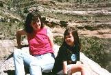 My daughters sitting on the edge of the mountain.