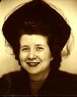 My mom as a young woman showing off her hat.  Click for slightly larger view.