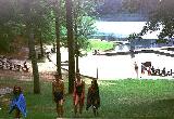 My daughter and two friends walking up from the lake.