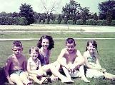 Me with 4 of my sibs in our old bathing suits, in front of our house.