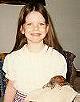 Anna holding her favorite turtle, Hurricane, on a pillow of sorts.