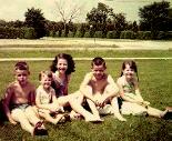 In our front yard,
 facing the cemetary, wearing our bathing suits.