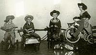 Four of us on our riding toys, about 1952.